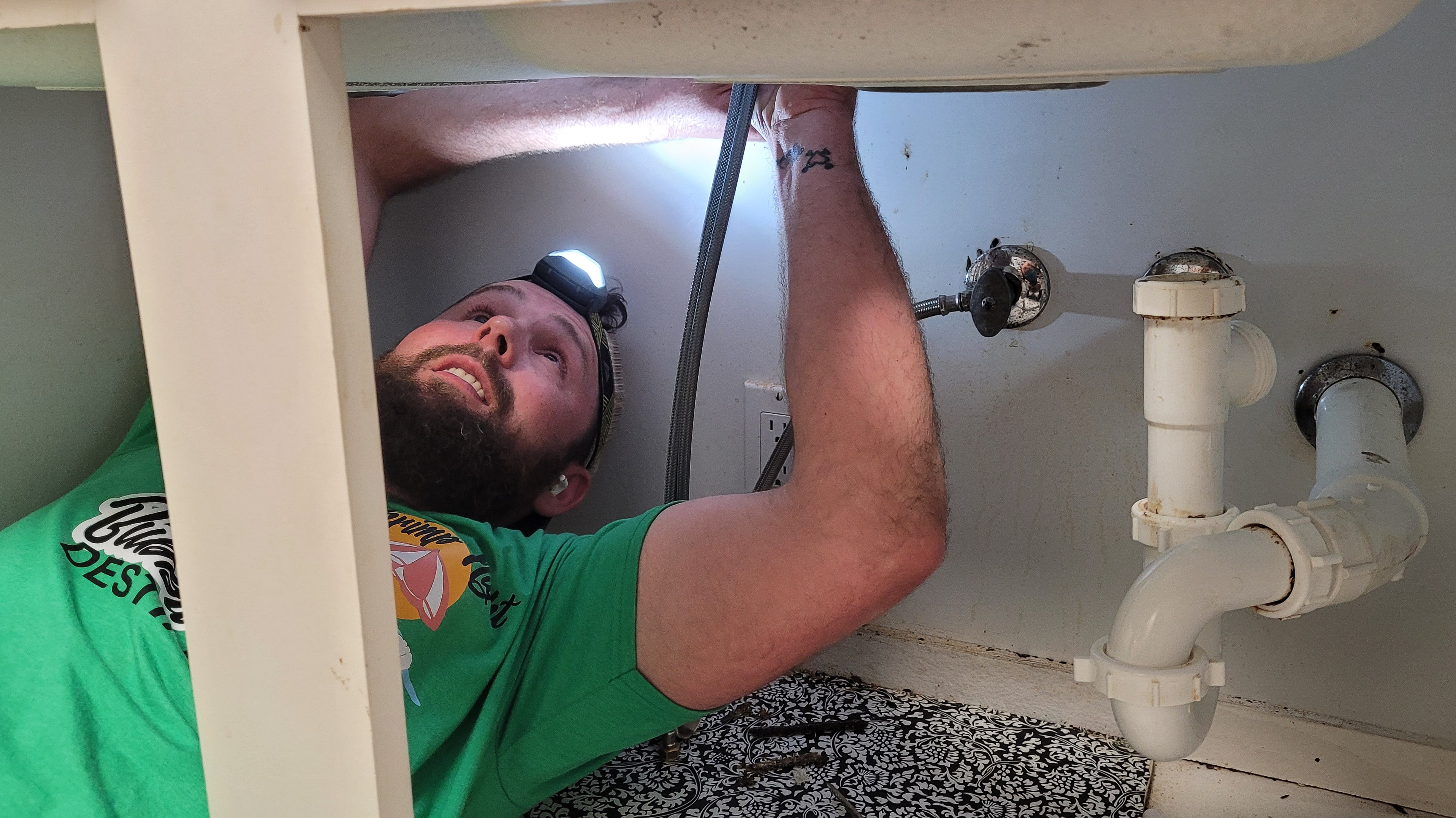 millennial-repairman-on-back-under-sink-installing-2026-01-09-00-02-56-utc