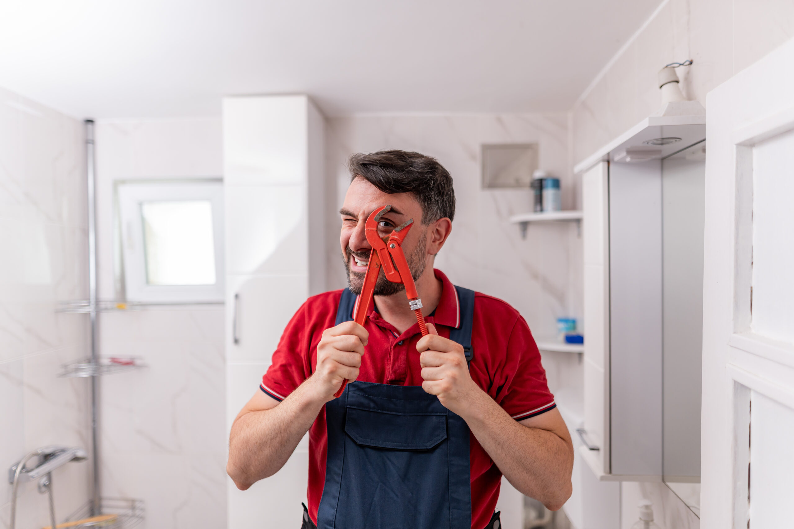 plumber-smiling-while-holding-adjustable-wrench-in-2026-01-09-12-12-32-utc
