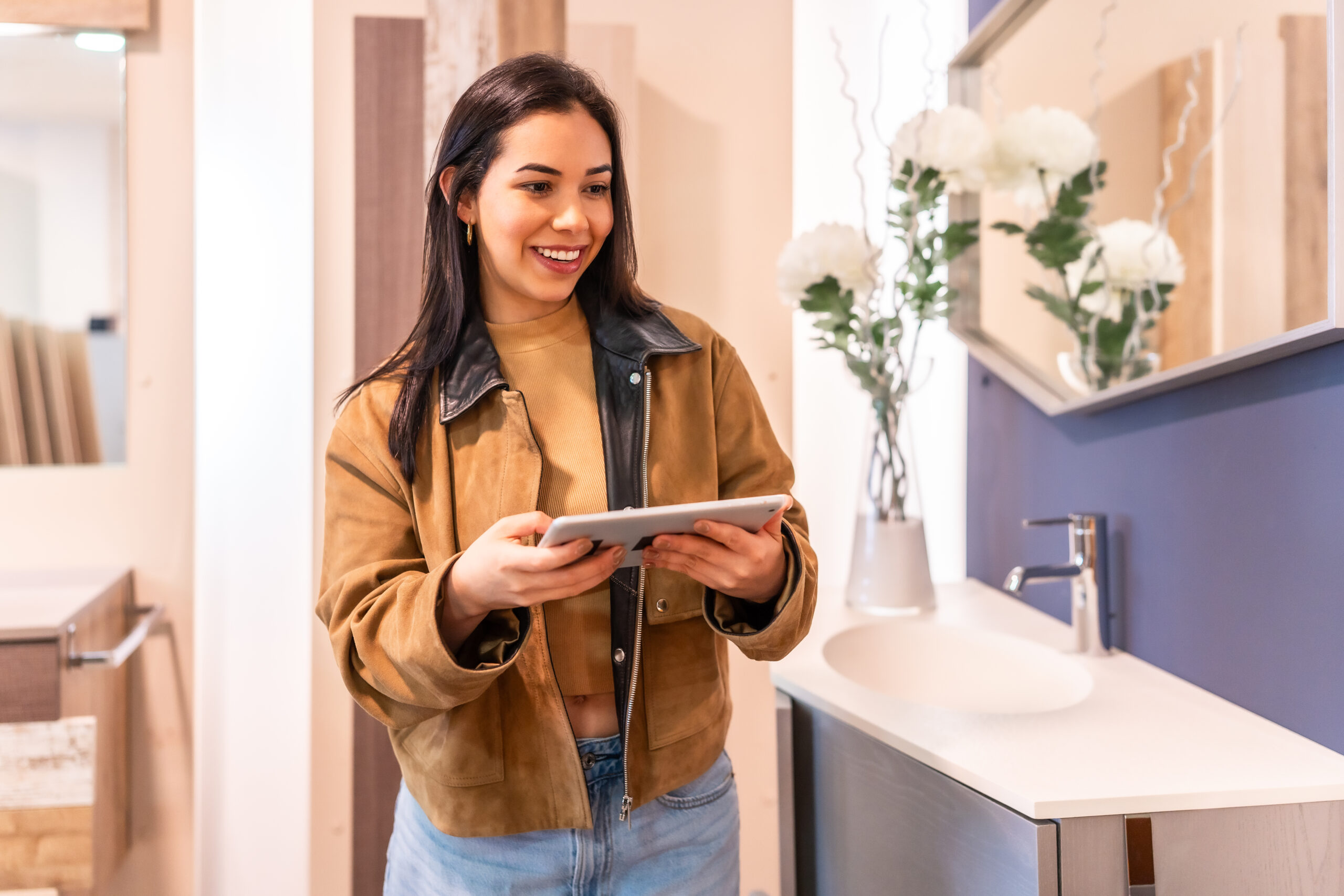 Woman using digital tablet in home improvement store for bathroom renovation