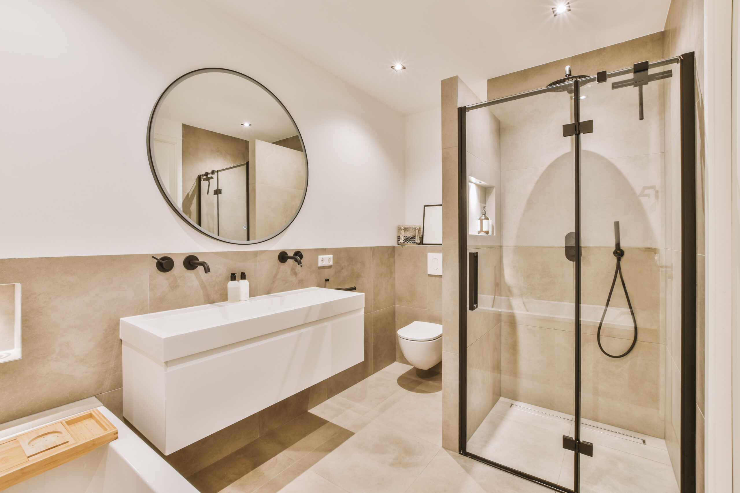 a bathroom with a shower, sink and toilet in the corner area next to the bathtub there is a mirror on the wall