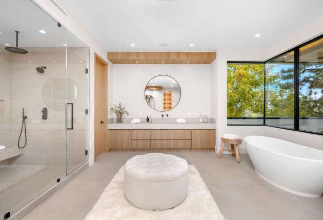 A white bathroom with bathtub and shower.