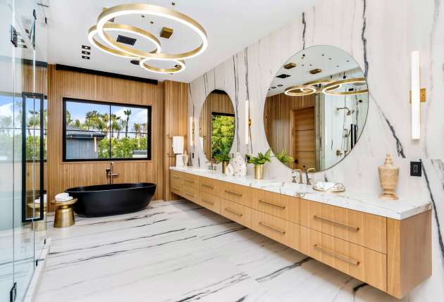A luxury modern bathroom featuring a black bathtub and elegant marble flooring.
